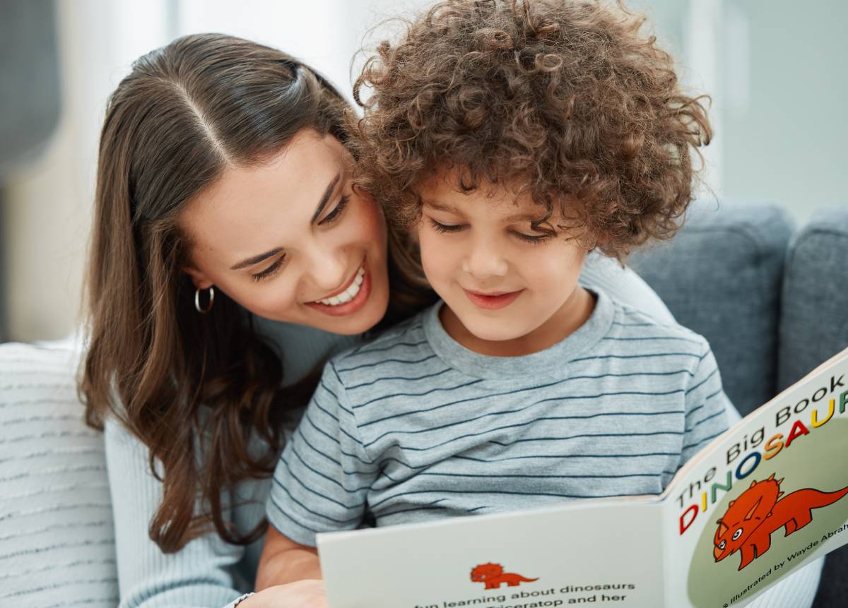 Mother and son reading book together.